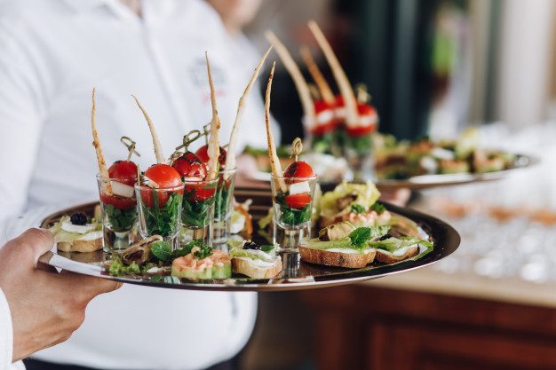 waiter-keeps-salver-with-snacks_8353-9582.jpg